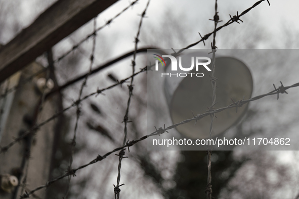 A close-up view of a lamp mounted on the wire fence of the Dachau Nazi concentration camp in Dachau, on April 4, 2023. 