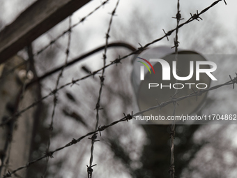 A close-up view of a lamp mounted on the wire fence of the Dachau Nazi concentration camp in Dachau, on April 4, 2023. (