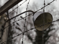 A close-up view of a lamp mounted on the wire fence of the Dachau Nazi concentration camp in Dachau, on April 4, 2023. (