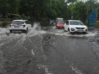 Motorists make their way through a flooded road after Cyclone Dana thrashes the city with heavy rain, as seen in Kolkata, India, on October...