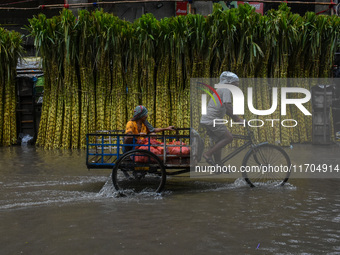 A flooded road is seen in Kolkata, India, on October 25, 2024, after heavy rain brought by the landfall of Cyclone Dana. Cyclone Dana makes...