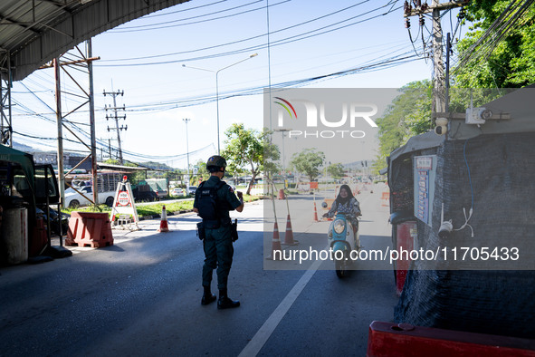 An armed soldier waves a motorcyclist through a checkpoint in Yala. Daily life in Tak Bai, Narathiwat, Thailand, on October 25, 2024. Tak Ba...