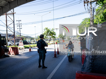 An armed soldier waves a motorcyclist through a checkpoint in Yala. Daily life in Tak Bai, Narathiwat, Thailand, on October 25, 2024. Tak Ba...