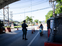 An armed soldier waves a motorcyclist through a checkpoint in Yala. Daily life in Tak Bai, Narathiwat, Thailand, on October 25, 2024. Tak Ba...