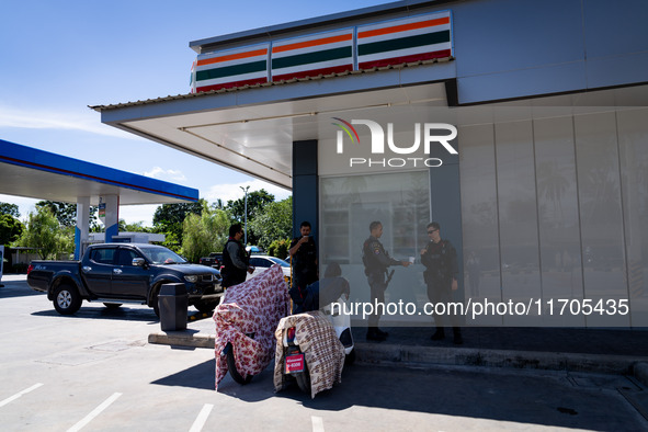 Armed soldiers stand guard at a 7-Eleven in Tak Bai, Narathiwat, Thailand, on October 25, 2024. Tak Bai is the site of an incident that resu...