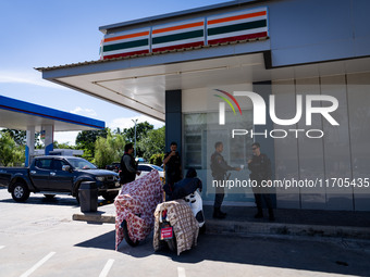 Armed soldiers stand guard at a 7-Eleven in Tak Bai, Narathiwat, Thailand, on October 25, 2024. Tak Bai is the site of an incident that resu...