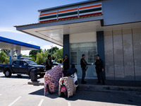 Armed soldiers stand guard at a 7-Eleven in Tak Bai, Narathiwat, Thailand, on October 25, 2024. Tak Bai is the site of an incident that resu...