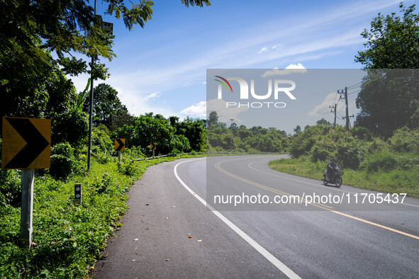 A motorcyclist rides on the rural highway between Pattani and Narathiwat. Daily life in Tak Bai, Narathiwat, Thailand, on October 25, 2024....