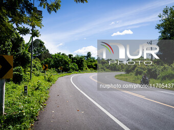 A motorcyclist rides on the rural highway between Pattani and Narathiwat. Daily life in Tak Bai, Narathiwat, Thailand, on October 25, 2024....