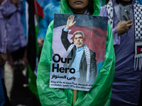 A protester holds a placard during a rally in solidarity with the Palestinian people outside the US embassy in Jakarta, Indonesia, on Octobe...