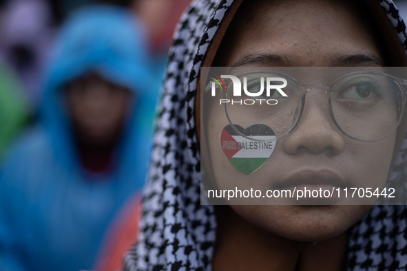 People take part in a rally in solidarity with the Palestinian people outside the US embassy in Jakarta, Indonesia, on October 25, 2024. The...