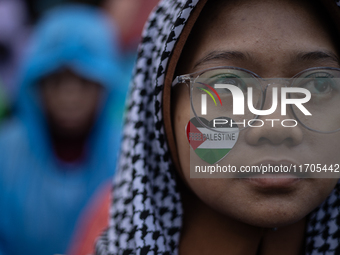 People take part in a rally in solidarity with the Palestinian people outside the US embassy in Jakarta, Indonesia, on October 25, 2024. The...