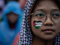 People take part in a rally in solidarity with the Palestinian people outside the US embassy in Jakarta, Indonesia, on October 25, 2024. The...