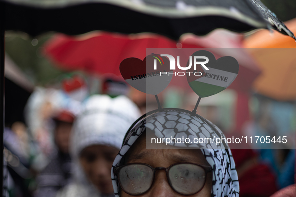 People take part in a rally in solidarity with the Palestinian people outside the US embassy in Jakarta, Indonesia, on October 25, 2024. The...