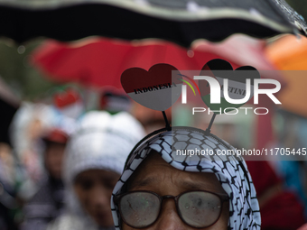 People take part in a rally in solidarity with the Palestinian people outside the US embassy in Jakarta, Indonesia, on October 25, 2024. The...