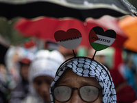 People take part in a rally in solidarity with the Palestinian people outside the US embassy in Jakarta, Indonesia, on October 25, 2024. The...