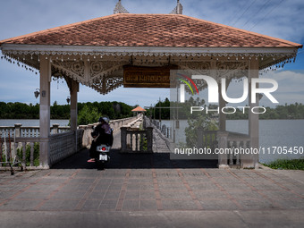 People ride motorcycles across a bridge in Tak Bai. Daily life in Tak Bai, Narathiwat, Thailand, on October 25, 2024. Tak Bai is the site of...