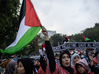 Protesters shout slogans during a rally in solidarity with the Palestinian people outside the US embassy in Jakarta, Indonesia, on October 2...