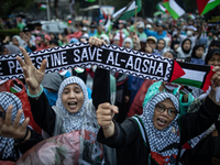 Protesters shout slogans during a rally in solidarity with the Palestinian people outside the US embassy in Jakarta, Indonesia, on October 2...