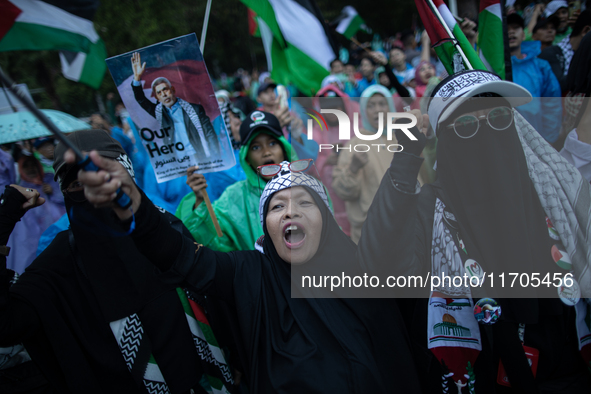 Protesters shout slogans during a rally in solidarity with the Palestinian people outside the US embassy in Jakarta, Indonesia, on October 2...