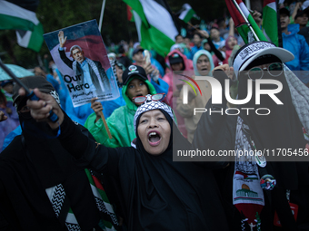 Protesters shout slogans during a rally in solidarity with the Palestinian people outside the US embassy in Jakarta, Indonesia, on October 2...