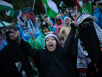 Protesters shout slogans during a rally in solidarity with the Palestinian people outside the US embassy in Jakarta, Indonesia, on October 2...