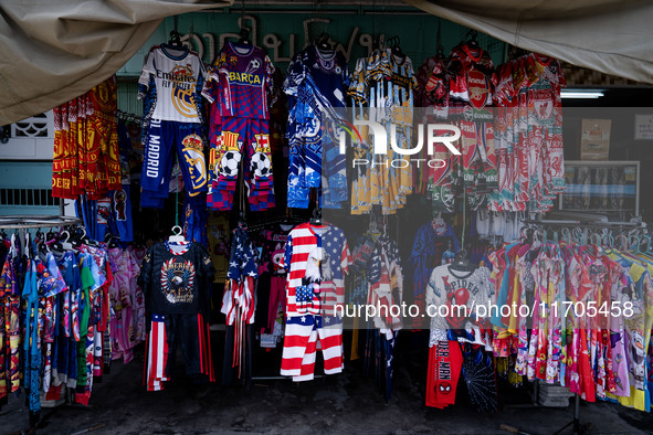 Various items, including USA merchandise, are for sale at a street vendor in Tak Bai. Daily life continues in Tak Bai, Narathiwat, Thailand,...