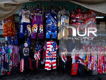 Various items, including USA merchandise, are for sale at a street vendor in Tak Bai. Daily life continues in Tak Bai, Narathiwat, Thailand,...