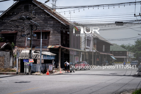 An armed checkpoint is next to an antique wooden house in the city center of Tak Bai. Daily life continues in Tak Bai, Narathiwat, Thailand,...