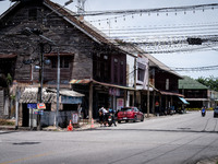 An armed checkpoint is next to an antique wooden house in the city center of Tak Bai. Daily life continues in Tak Bai, Narathiwat, Thailand,...