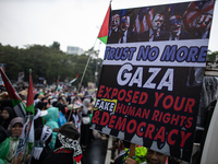 People take part in a rally in solidarity with the Palestinian people outside the US embassy in Jakarta, Indonesia, on October 25, 2024. The...