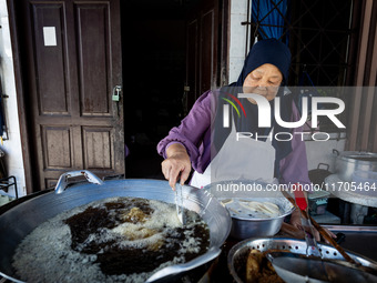 A street food vendor fries bananas in Tak Bai. Daily life in Tak Bai, Narathiwat, Thailand, on October 25, 2024. Tak Bai is the site of an i...