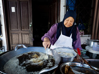 A street food vendor fries bananas in Tak Bai. Daily life in Tak Bai, Narathiwat, Thailand, on October 25, 2024. Tak Bai is the site of an i...