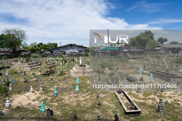 A Muslim cemetery is located outside of Ihsaniyah Mosque in Tak Bai. Daily life occurs in Tak Bai, Narathiwat, Thailand, on October 25, 2024...