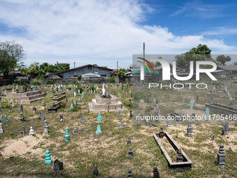 A Muslim cemetery is located outside of Ihsaniyah Mosque in Tak Bai. Daily life occurs in Tak Bai, Narathiwat, Thailand, on October 25, 2024...