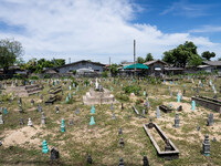 A Muslim cemetery is located outside of Ihsaniyah Mosque in Tak Bai. Daily life occurs in Tak Bai, Narathiwat, Thailand, on October 25, 2024...