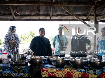 Customers grab lunch after praying at a mosque in Tak Bai. Daily life in Tak Bai, Narathiwat, Thailand, on October 25, 2024, reflects the hi...