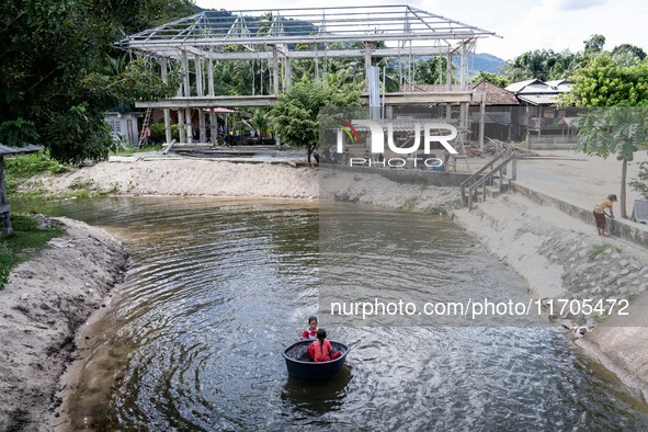 Children play in the river at Wadil-Husen Mosque in Pattani. Daily life occurs in Tak Bai, Narathiwat, Thailand, on October 25, 2024. Tak Ba...