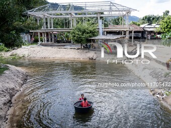 Children play in the river at Wadil-Husen Mosque in Pattani. Daily life occurs in Tak Bai, Narathiwat, Thailand, on October 25, 2024. Tak Ba...