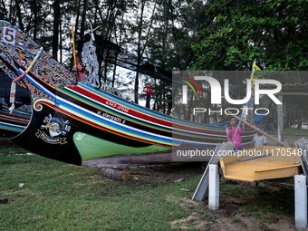 A longtail boat maker works on a new vessel at a park in Narathiwat. Daily life in Tak Bai, Narathiwat, Thailand, on October 25, 2024. Tak B...