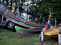 A longtail boat maker works on a new vessel at a park in Narathiwat. Daily life in Tak Bai, Narathiwat, Thailand, on October 25, 2024. Tak B...