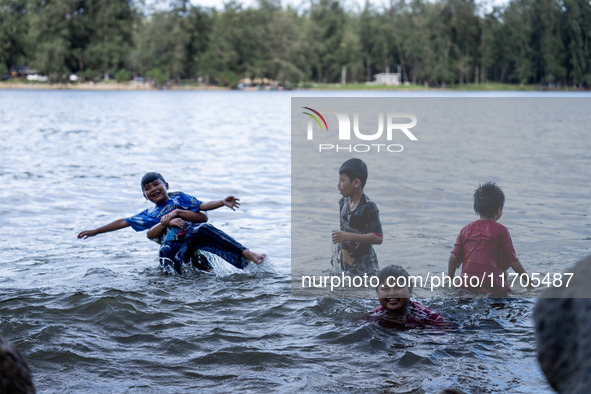 Children play in the sea in Narathiwat. Daily life in Tak Bai, Narathiwat, Thailand, on October 25, 2024. Tak Bai is the site of an incident...