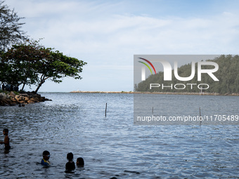 Children play in the sea in Narathiwat. Daily life in Tak Bai, Narathiwat, Thailand, on October 25, 2024. Tak Bai is the site of an incident...