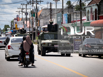 Soldiers in an APC patrol Tak Bai town. Daily life in Tak Bai, Narathiwat, Thailand, on October 25, 2024. Tak Bai is the site of an incident...