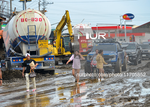 Residents in Lemery, Batangas, were seen cleaning up mud and debris on October 25, 2024, after Tropical Storm Kristine caused severe floodin...