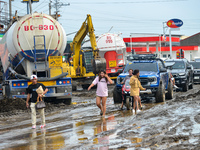 Residents in Lemery, Batangas, were seen cleaning up mud and debris on October 25, 2024, after Tropical Storm Kristine caused severe floodin...