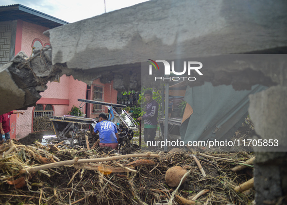 Residents in Lemery, Batangas, were seen cleaning up mud and debris on October 25, 2024, after Tropical Storm Kristine caused severe floodin...