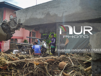 Residents in Lemery, Batangas, were seen cleaning up mud and debris on October 25, 2024, after Tropical Storm Kristine caused severe floodin...