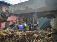 Residents in Lemery, Batangas, were seen cleaning up mud and debris on October 25, 2024, after Tropical Storm Kristine caused severe floodin...