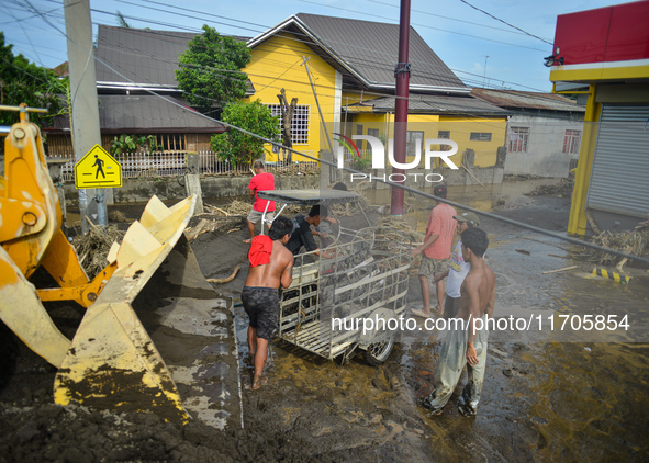 Residents in Lemery, Batangas, were seen cleaning up mud and debris on October 25, 2024, after Tropical Storm Kristine caused severe floodin...